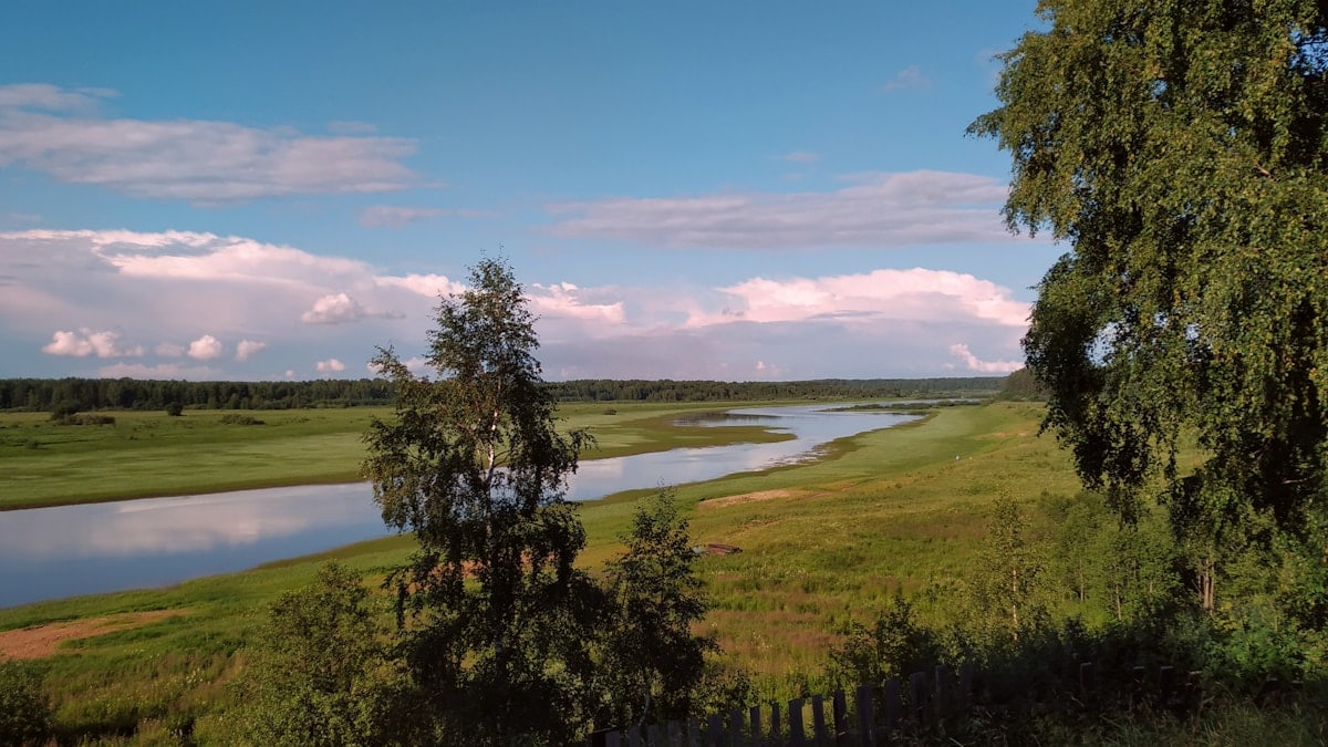 a river running through a lush green countryside
